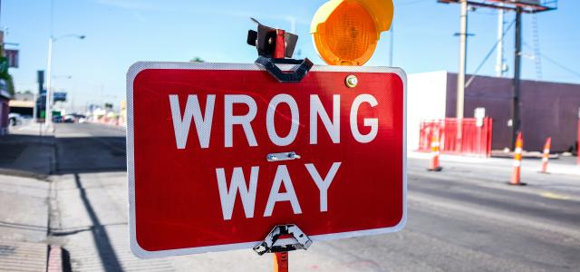 red Wrong Way signage on road by Kenny Eliason courtesy of Unsplash.